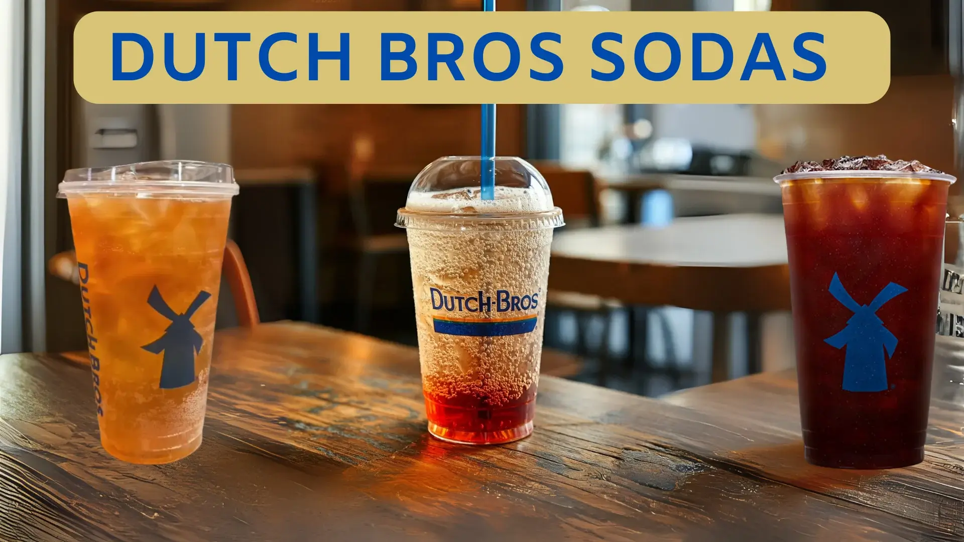 Three Dutch Bros sodas on a wooden table, showcasing vibrant flavors in a cozy cafe setting.