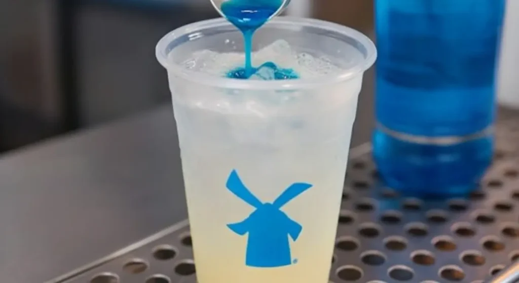 Dutch Bros Lemonade Concentrate mixing in a drink.