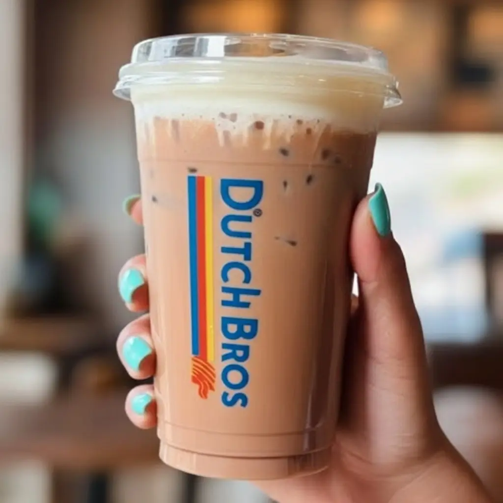 7 Dutch Bros Iced Coffee Drinks To Try 3 A woman hand taking dutch bros Iced Mocha drinks.